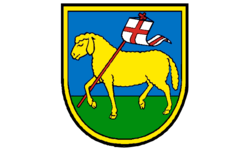 Das Wappen der Gemeinde Machtolsheim zeigt ein gelbes Lamm, das mit einer weißen Fahne, die ein rotes Kreuz trägt,  auf grünem Boden vor blauem Himmel steht, umgeben von einem gelben Schildrand.